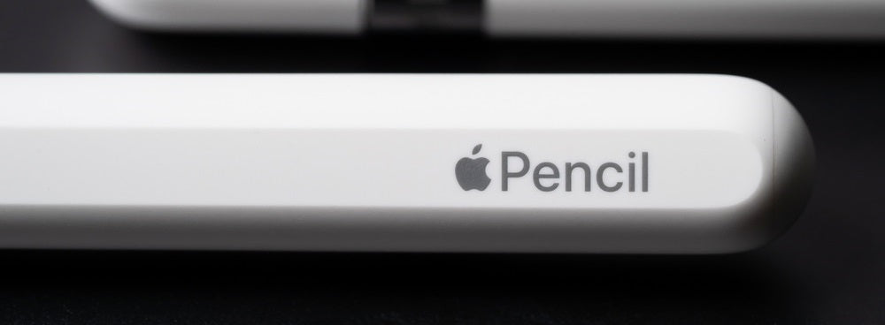 Close-up of an Apple Pencil on a black surface