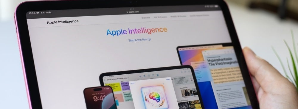 Man hand holding Apple iPad with home screen iPadOS 18 AI Apple Intelligence on the screen