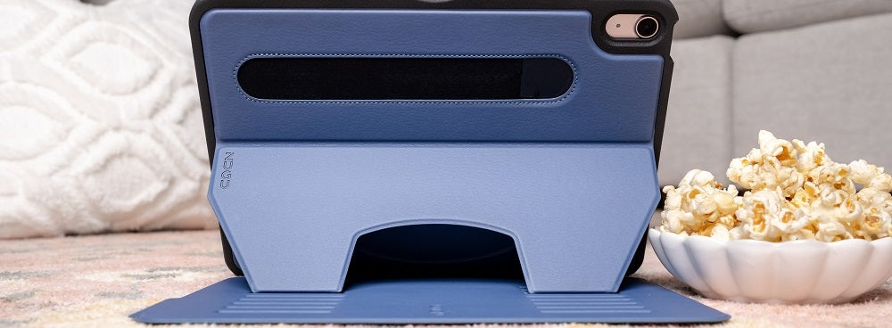 Person smiling while watching a tablet with a blue case in stand mode