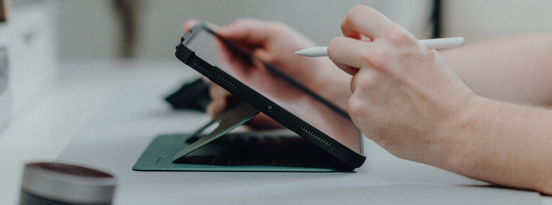 Person using Apple Pencil on iPad with ZUGU Case