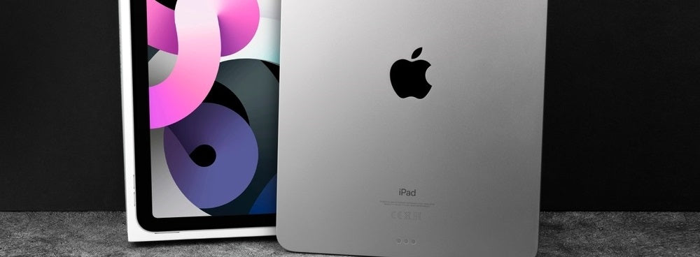 Silver Apple iPad Air tablet (2020) with a box on a dark background
