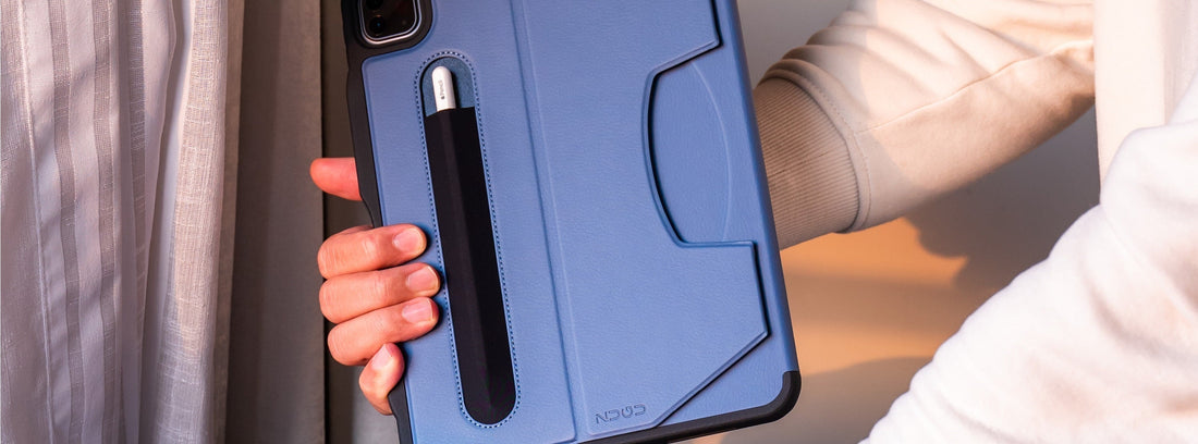 a man’s hands packing an iPad in a blue Zugu case into his backpack