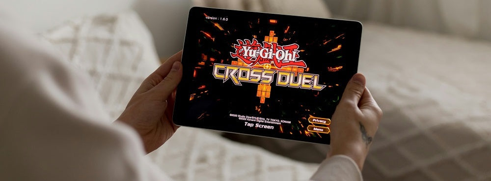 a person holding a tablet with a video game on it