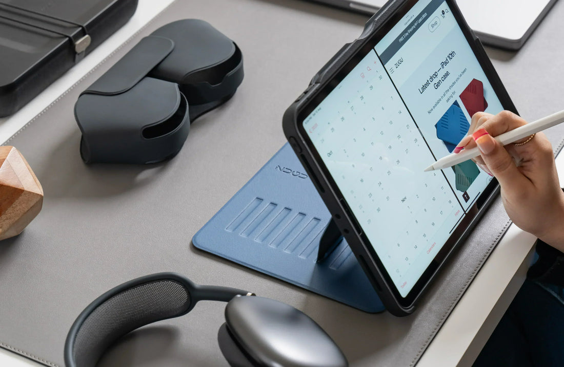 An iPad in a ZUGU case, being used as an organizer, on a desk with headphones beside it. 