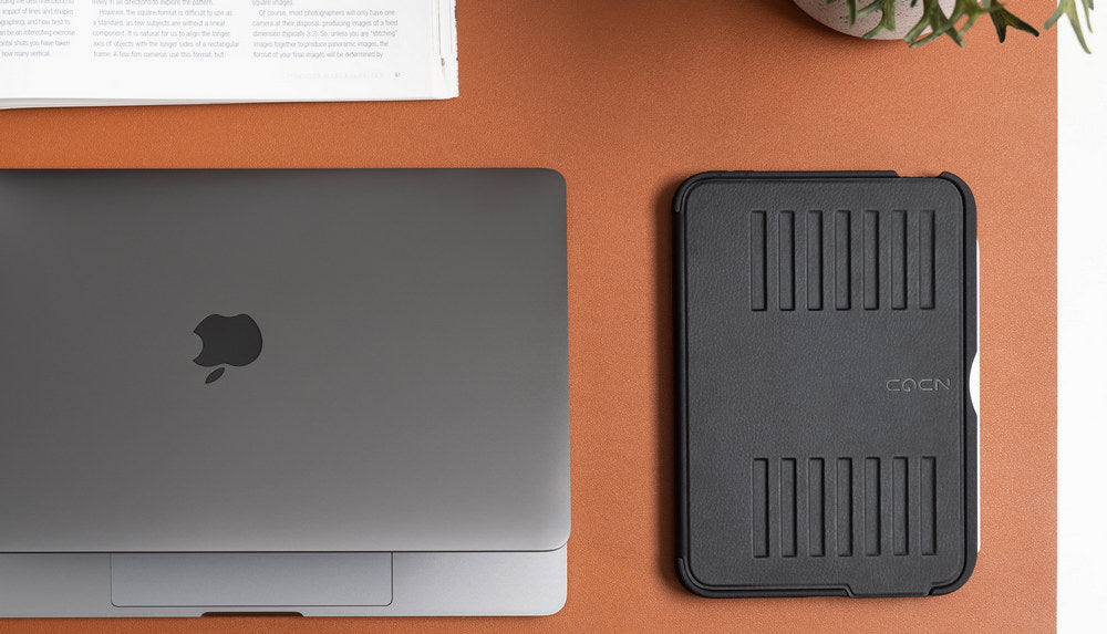 MacBook and ZUGU iPad case on a desk, comparing portable computing options for work and study. 