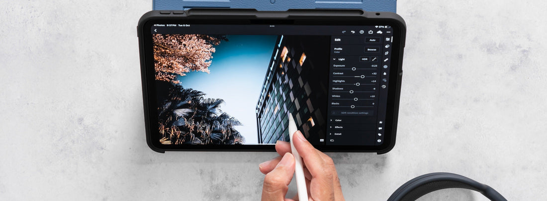 A hand writing on an iPad in ZUGU case