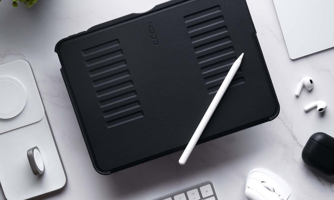 A ZUGU case on a desk surrounded by iPad accessories, like a mouse, keyboard, and Apple Pencil