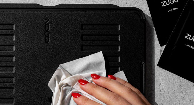 A ZUGU wipe being used to clean a ZUGU case